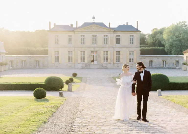 Bride and groom together in front of a château