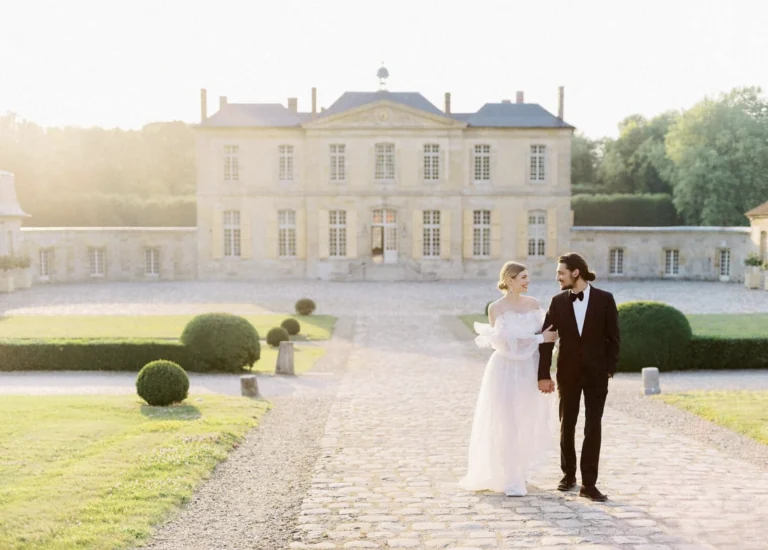 Bride and groom together in front of a château