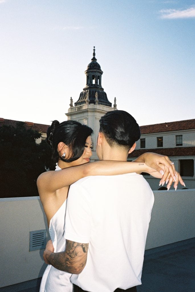 Elegant couple embracing with beautiful european style architecture backdrop