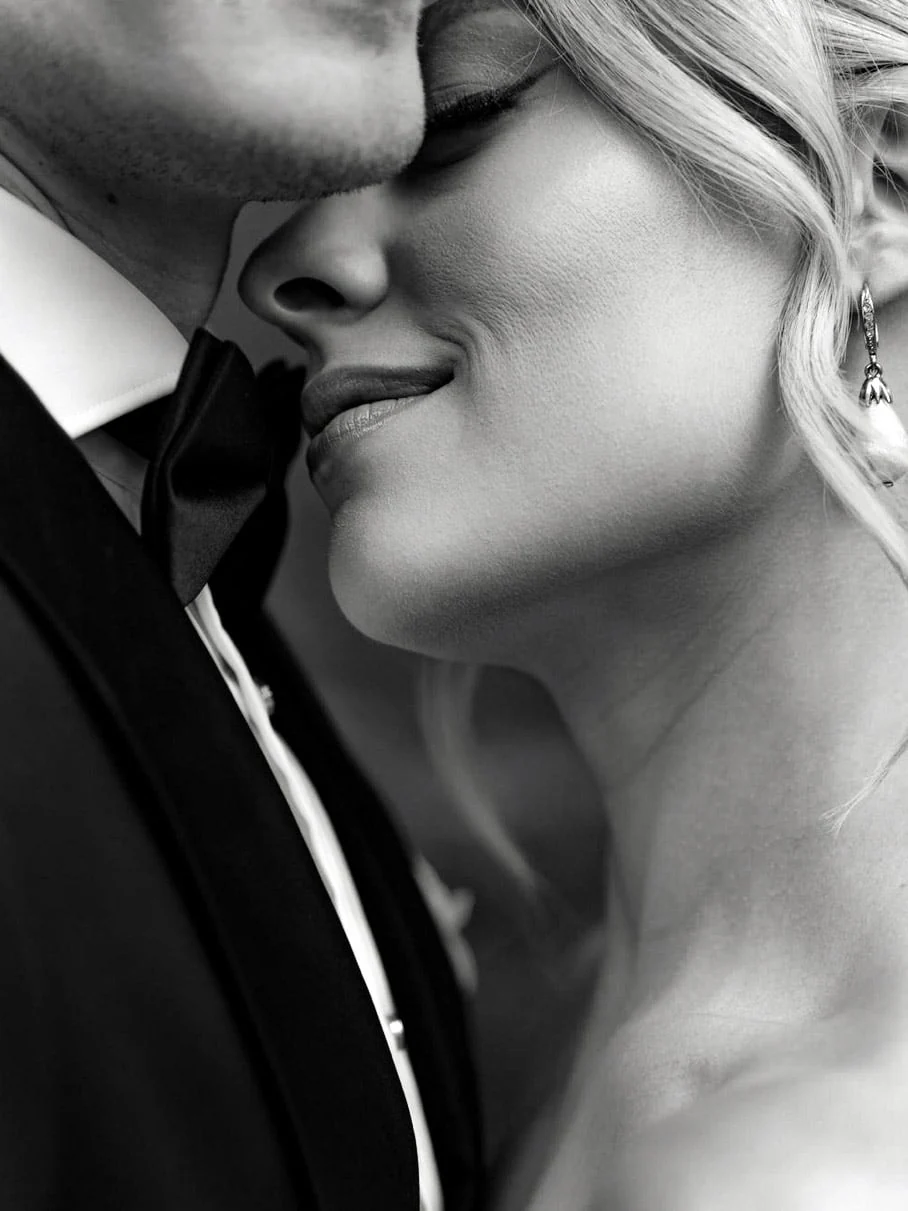 Bride and groom embracing in a black and white wedding portrait